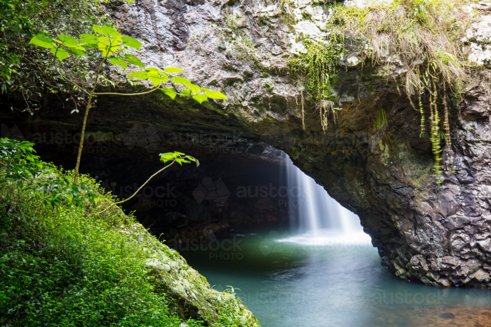 The majestic and iconic Natural Bridge on a warm autumn day in Springbrook National Park - Australian Stock Image