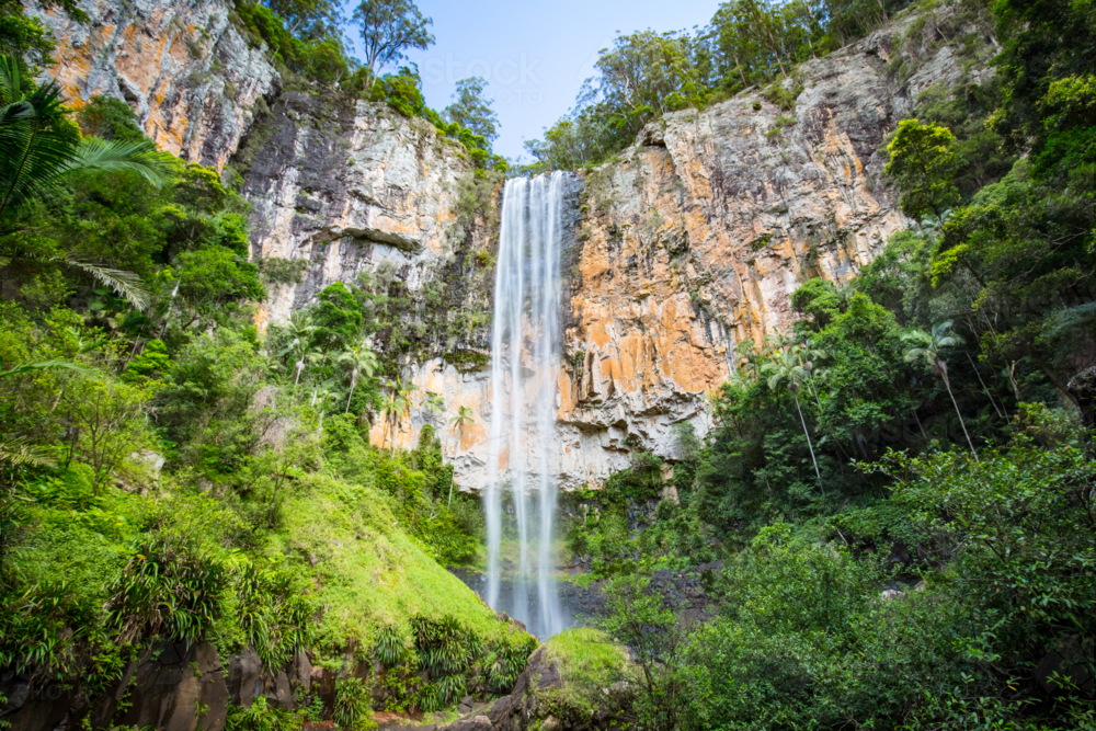 The majestic and iconic Purling Brook Falls on a warm autumn day in Springbrook National Park - Australian Stock Image