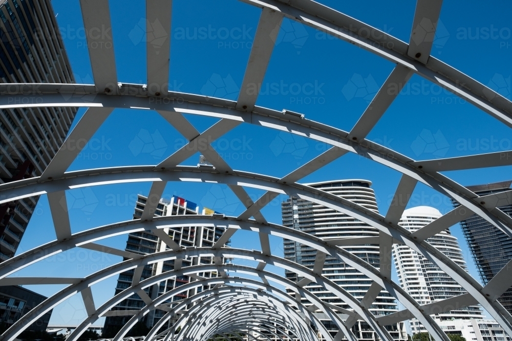 Image of The Net Bridge at Melbourne Docklands with city buildings in