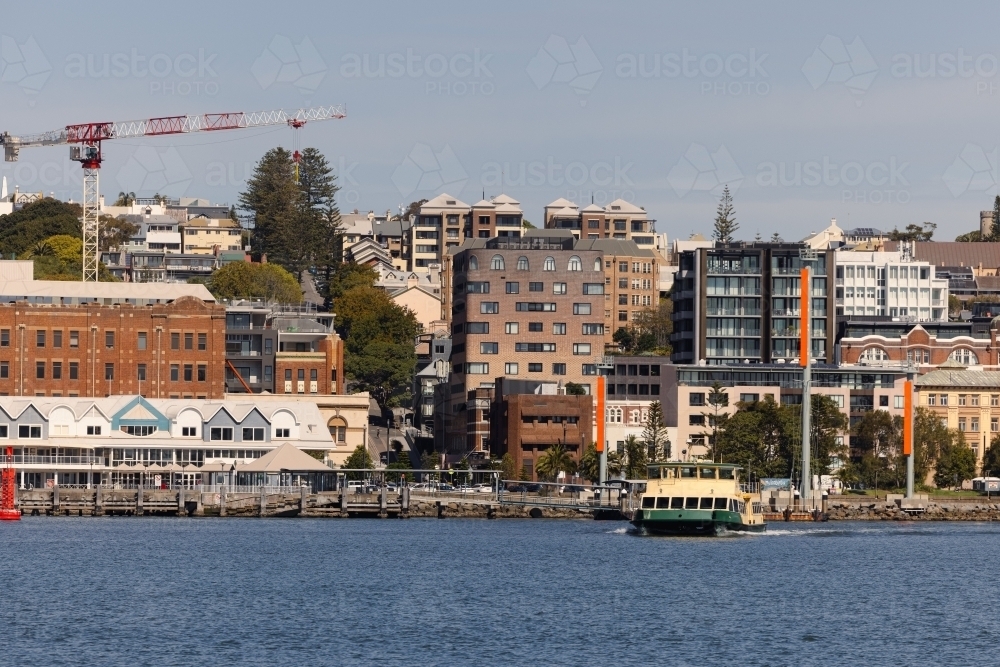 The Newcastle-Stockton ferry crossing the Hunter River with view of Newcastle city in background - Australian Stock Image