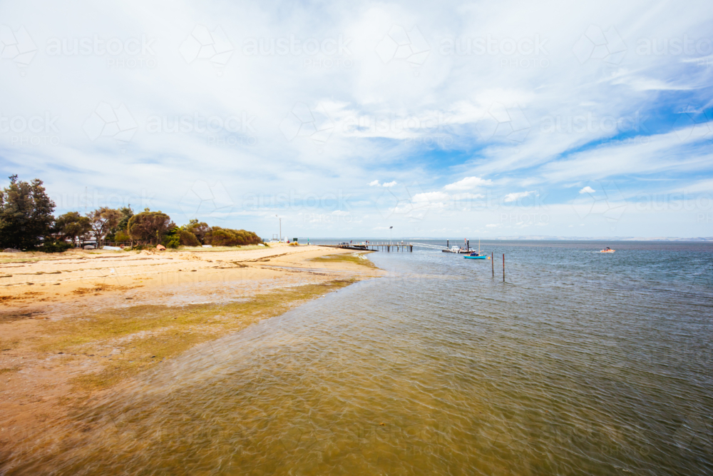 The quaint seaside fishing town of Rhyll with main beach and jetty in Victoria, Australia - Australian Stock Image