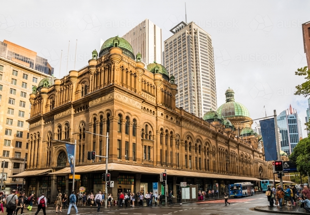 The Queen Victoria Building in the afternoon sunlight with pedestrians crossing Market Street - Australian Stock Image