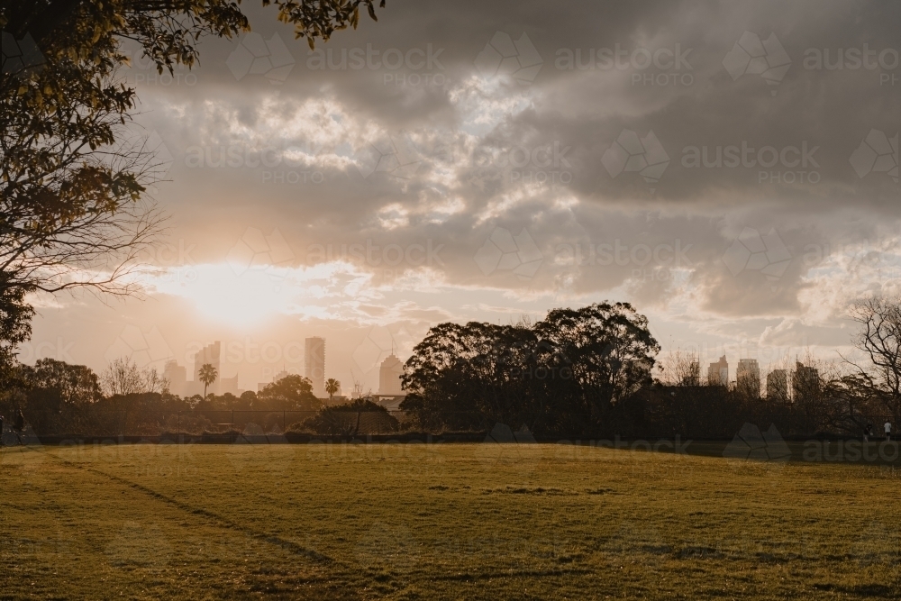 The Reservoir Fields sports field at sunset with Sydney city skyline in the distance - Australian Stock Image