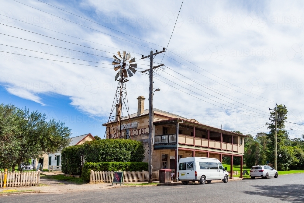 The Royal Hotel Cassilis a rural country pub on sunlit day with windmill - Australian Stock Image
