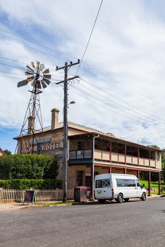 The Royal Hotel Cassilis a rural country pub on sunlit day with windmill - Australian Stock Image