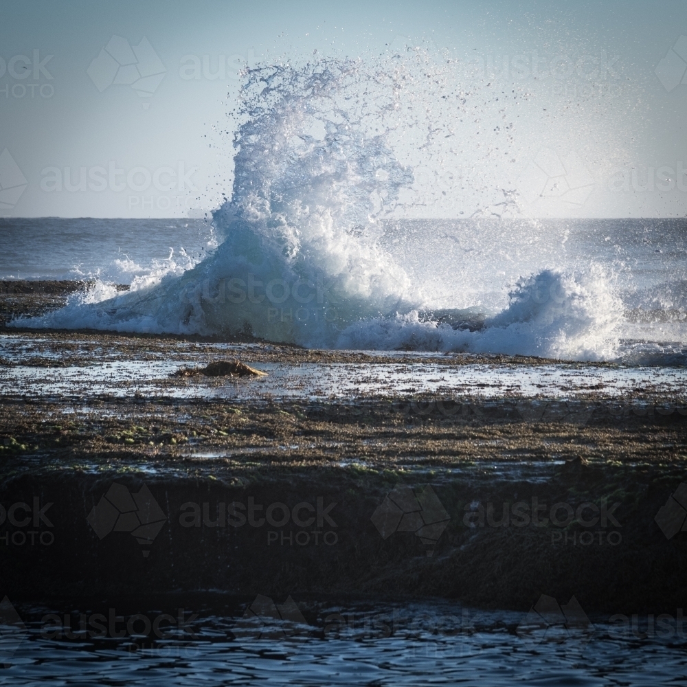 The sea crashes against the rock pools - Australian Stock Image
