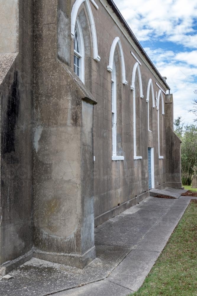 The side of an abandoned grey country church - Australian Stock Image