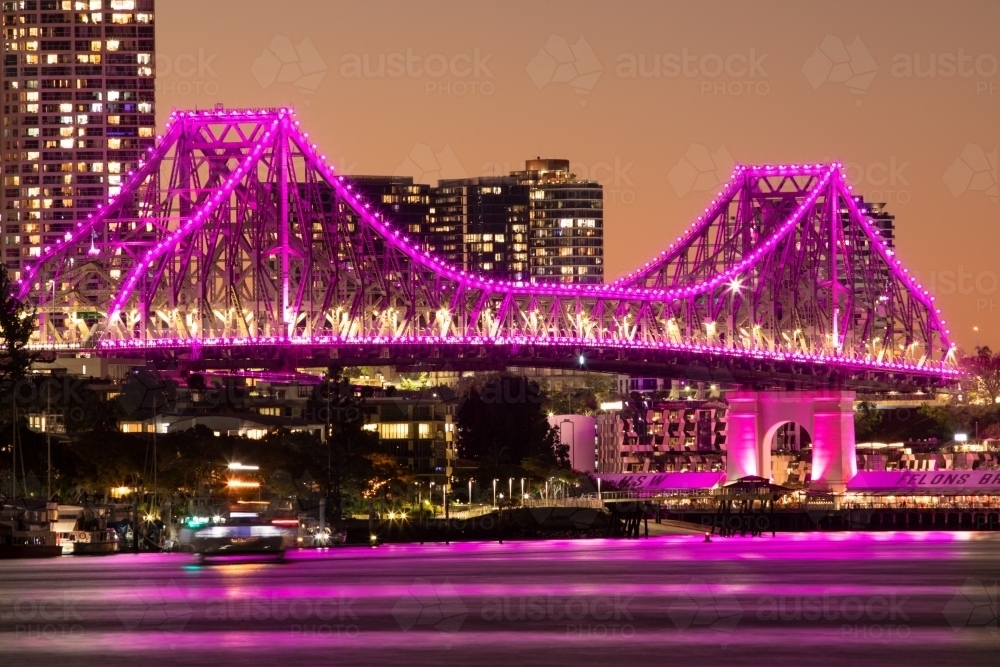 The Story Bridge illuminated magenta/pink after the sun has set - Australian Stock Image