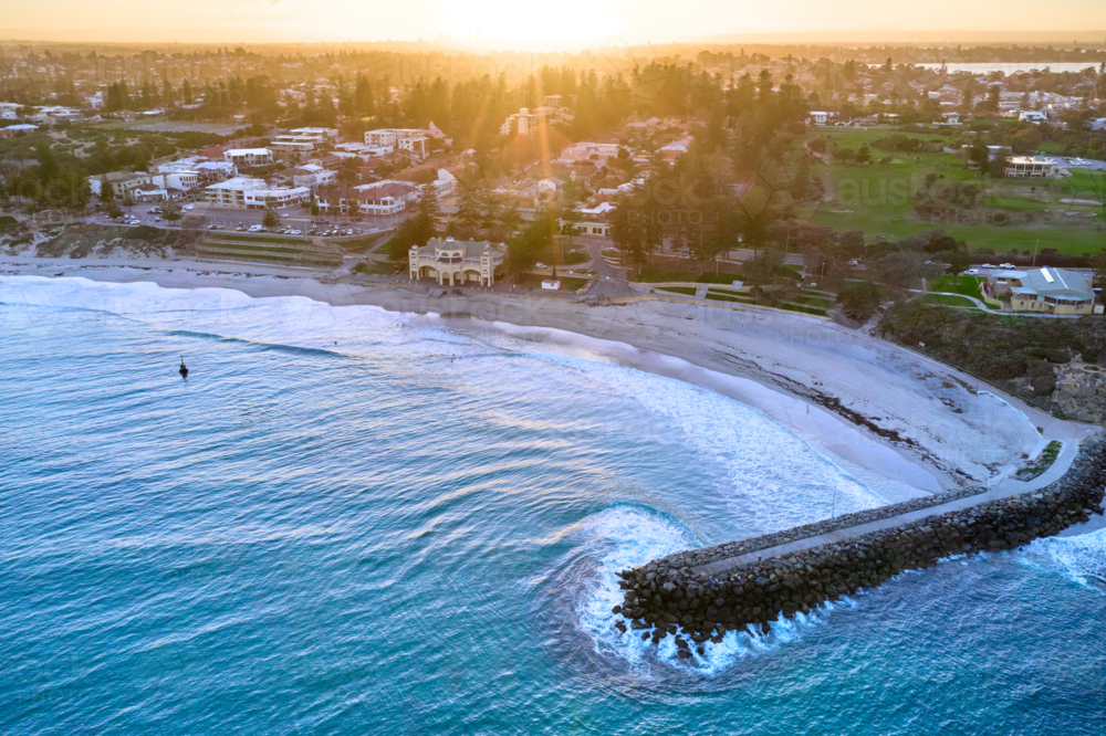 The sun rising on the horizon with an aerial view of Perth's famous Cottesloe beach : Austockphoto The sun rising on the horizon with an aerial view of Perth's famous Cottesloe beach - Australian Stock Image
