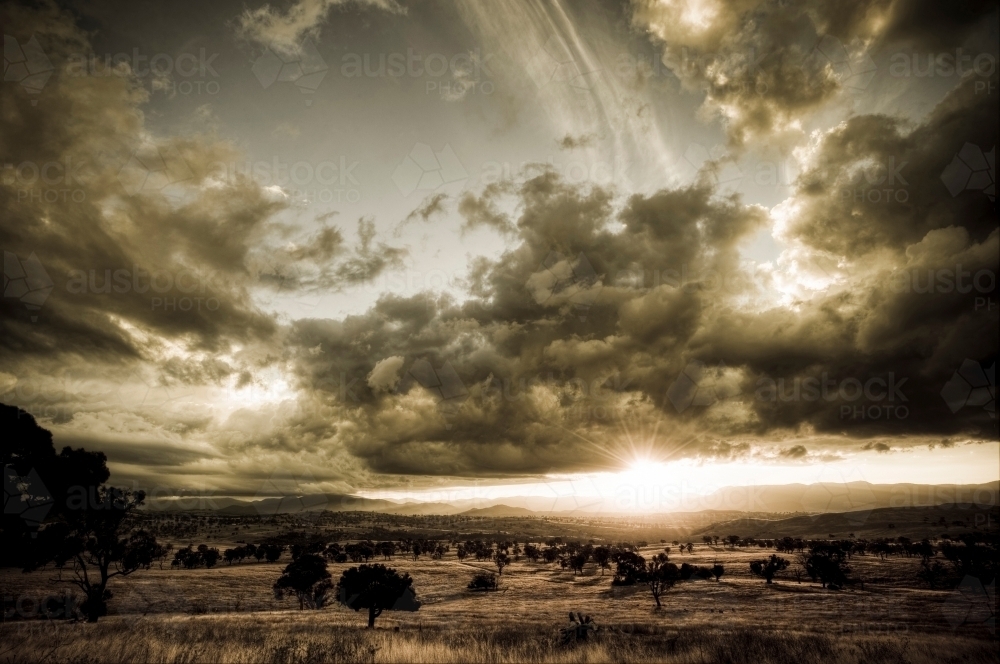 The sun sets over the Brindabella Range, west of Canberra - Australian Stock Image