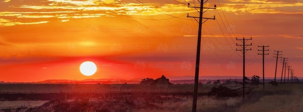 The Sun setting through a band of smoke - Australian Stock Image