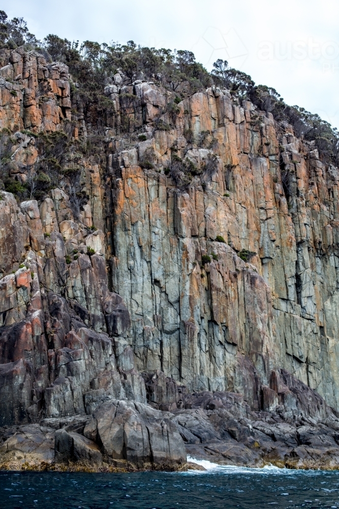The towering cliffs of Cape Hauy in Tasmania seen from the water - Australian Stock Image