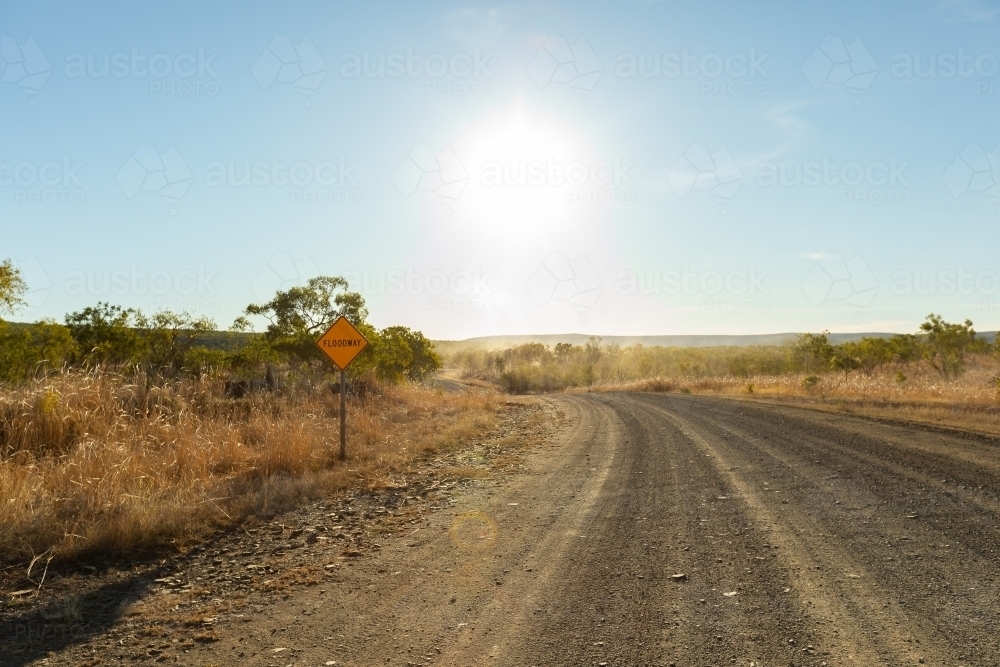 the unsealed Gibb River Road in the Kimberley with floodway sign - Australian Stock Image