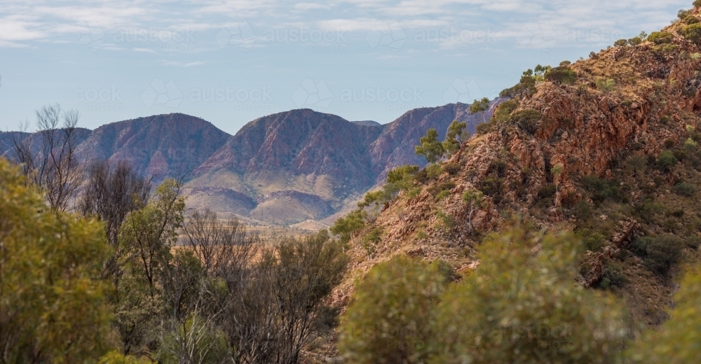 The West Macdonnell Ranges rising out of the earth - Australian Stock Image