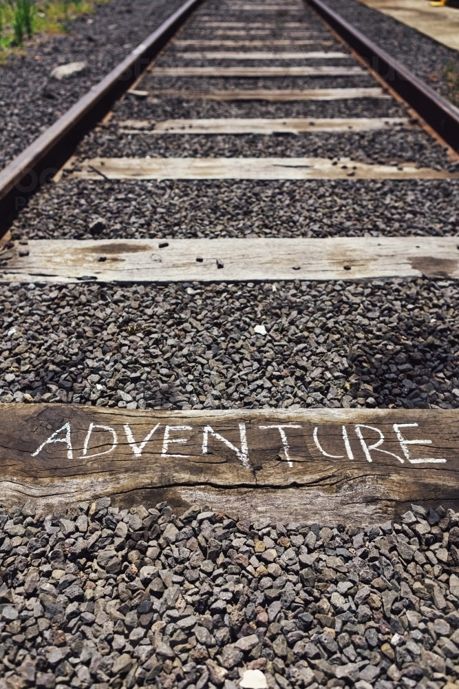 The word adventure written on a railway track sleeper - Australian Stock Image