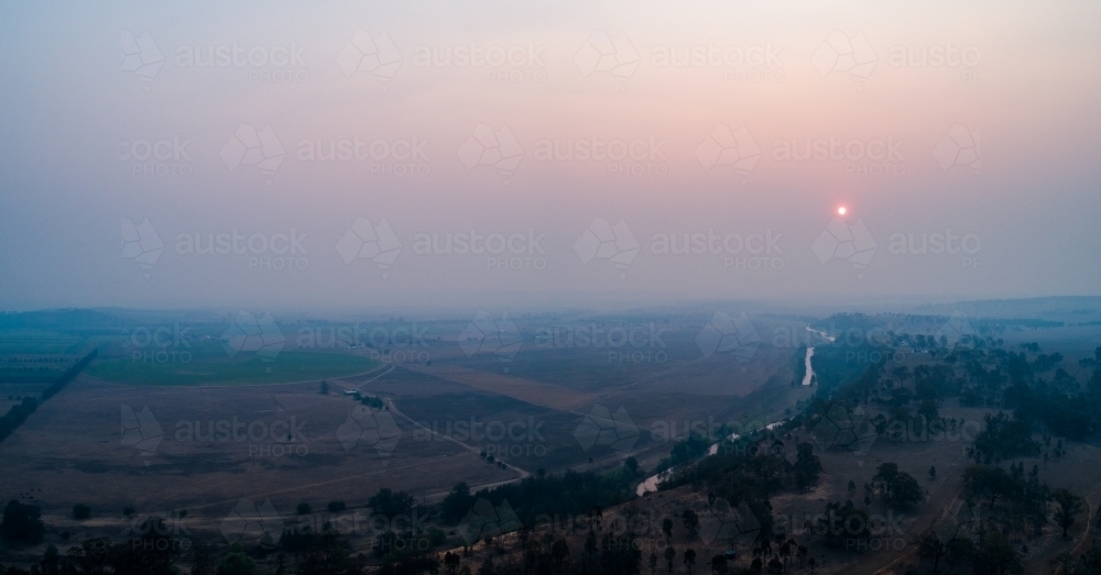 Thick smoke haze over farmland in hunter valley from bushfires - Australian Stock Image