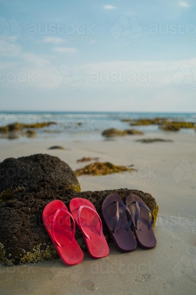 Image of Thongs on a beach - Austockphoto