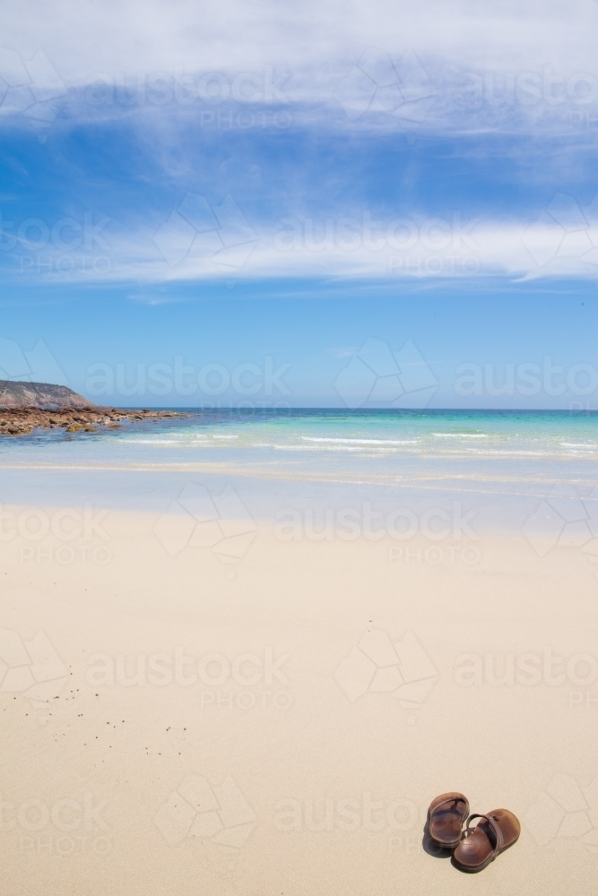 Thongs on a clean sandy beach - Australian Stock Image