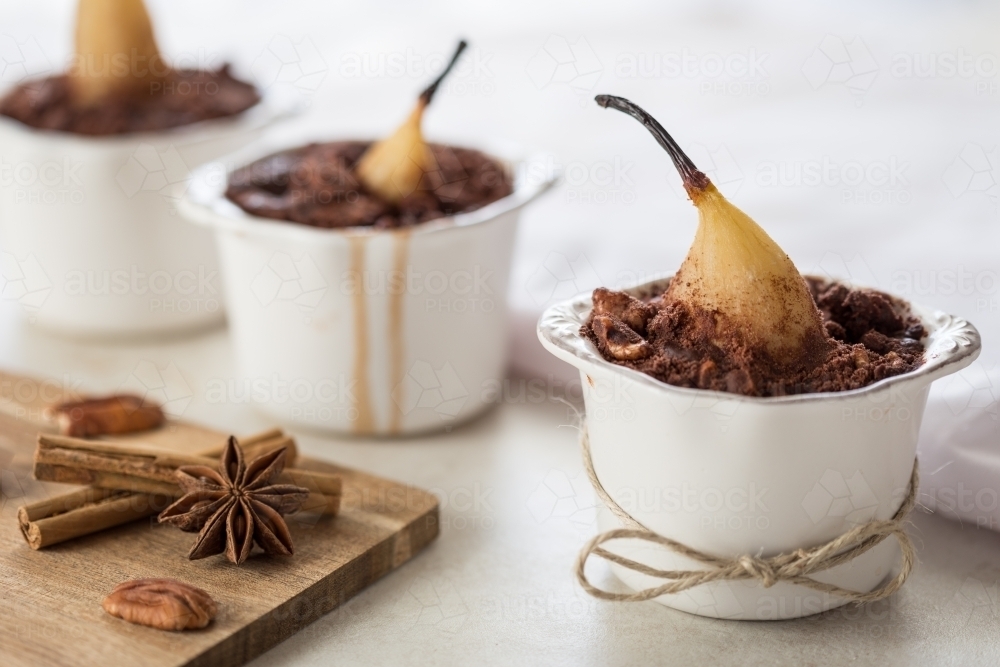 Three Baked Chocolate Pear Dessert in ramekins - Australian Stock Image