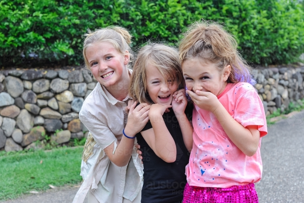 three cute giggling girls dressed up for a school play - Australian Stock Image