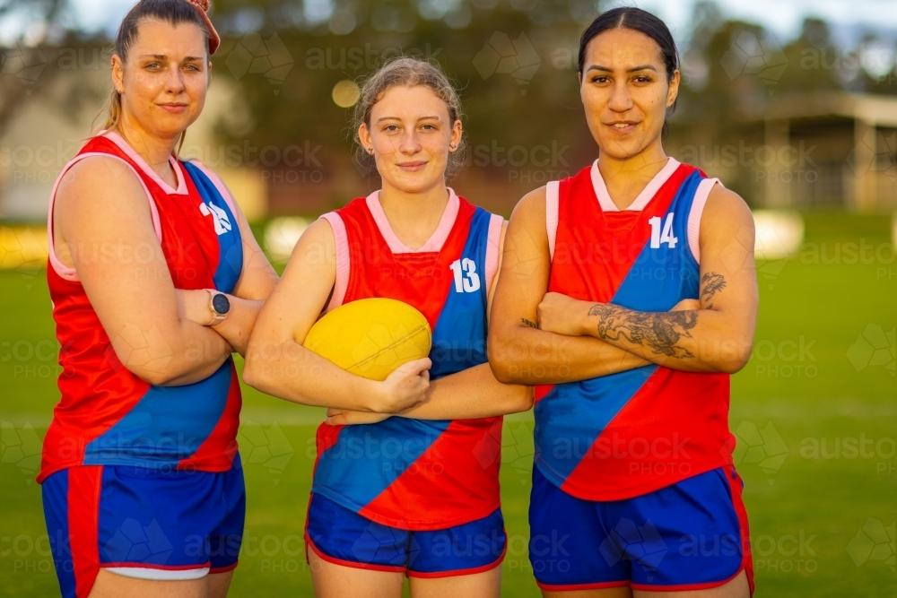 Three female football players standing with arms crossed - Australian Stock Image