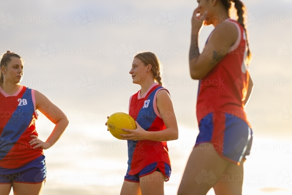 Three female football players talking  after a game - Australian Stock Image