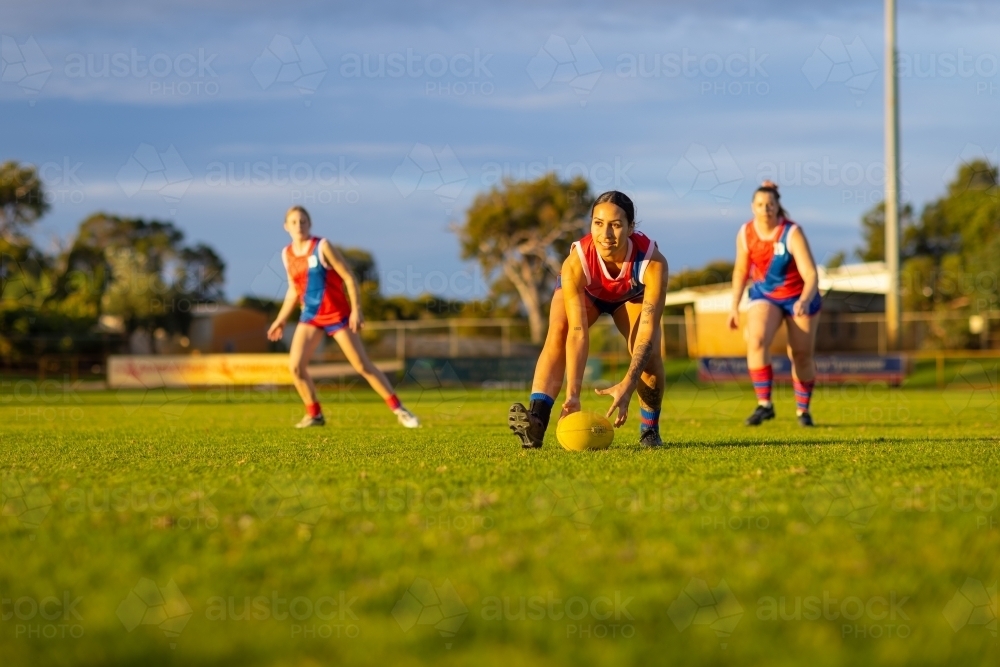 three female footballers at training - Australian Stock Image