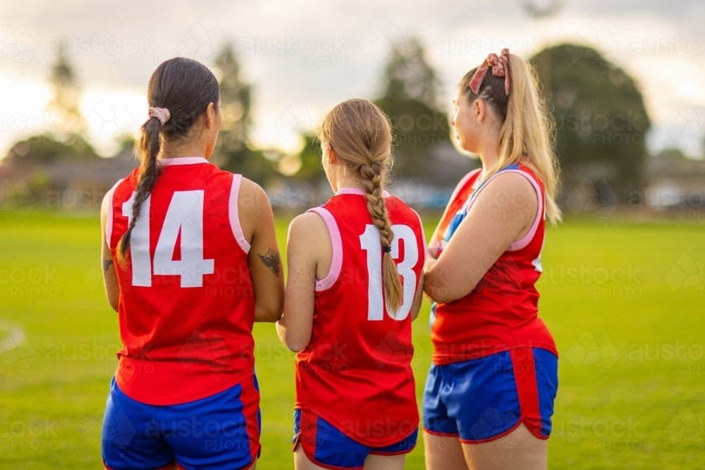 three female teammates in football uniforms at training - Australian Stock Image