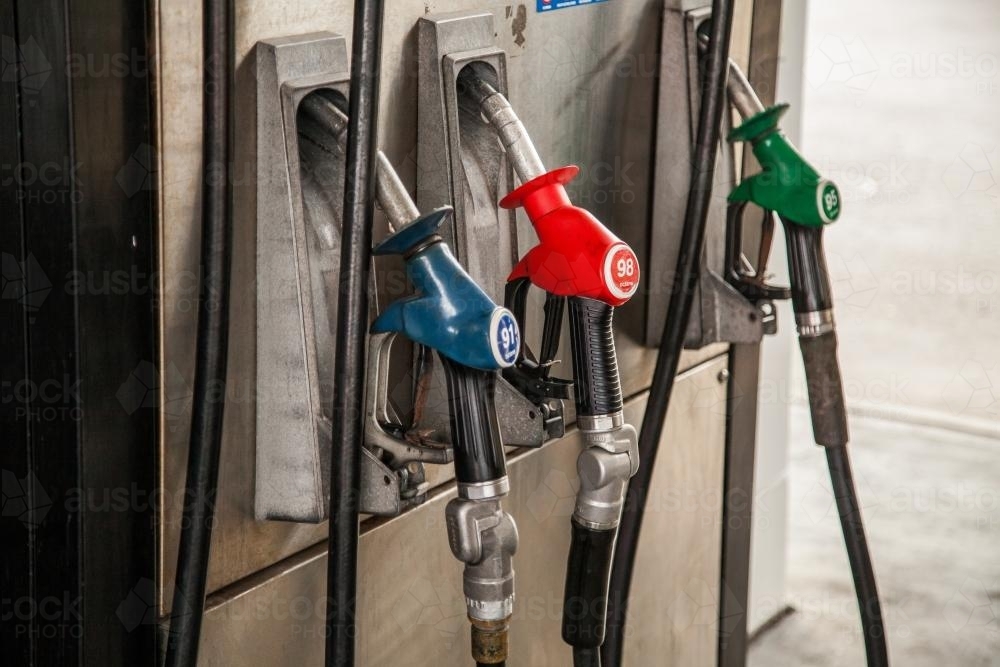 Three fuel dispenser nozzles at petrol pump - Australian Stock Image