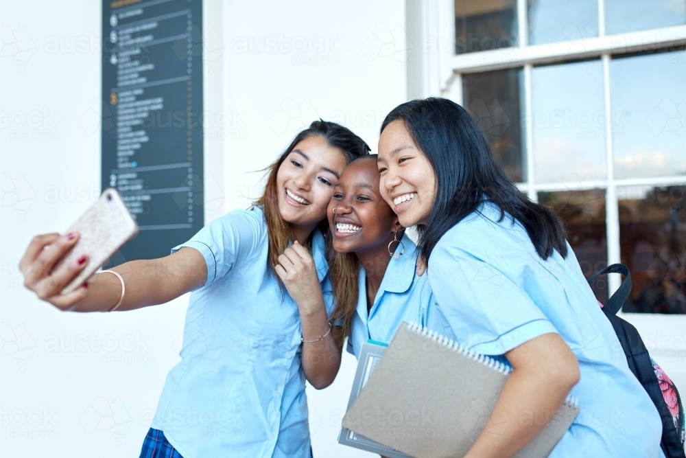 Three girlfriends taking a selfie at high school campus - Australian Stock Image