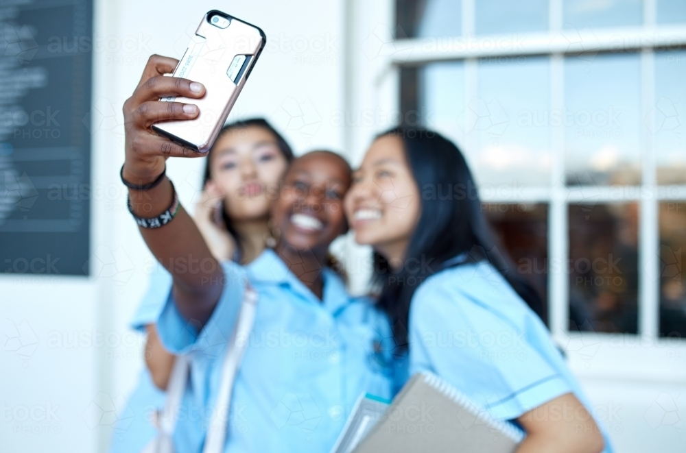 Three girlfriends taking a selfie at high school campus - Australian Stock Image