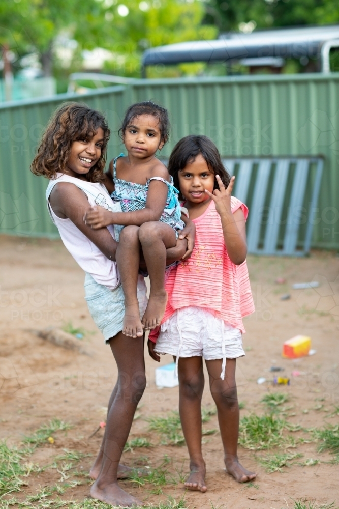 three little kids outside in their backyard in the Kimberley - Australian Stock Image