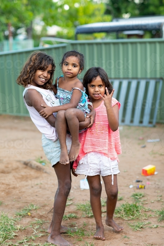 three little kids outside in their backyard in the Kimberley - Australian Stock Image