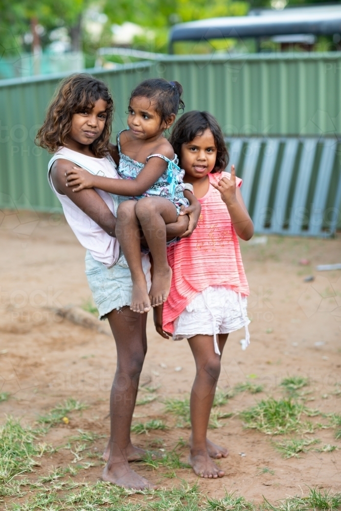 three little kids outside in their backyard in the Kimberley - Australian Stock Image