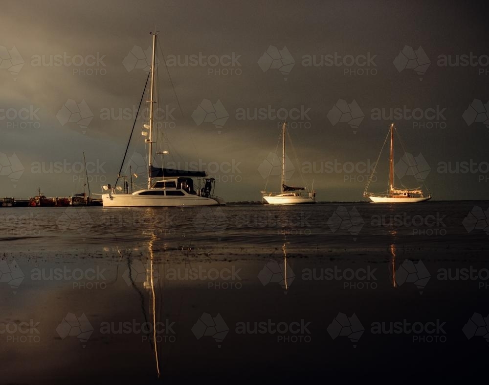 Three Moored Yachts in the Setting Sunlight - Australian Stock Image