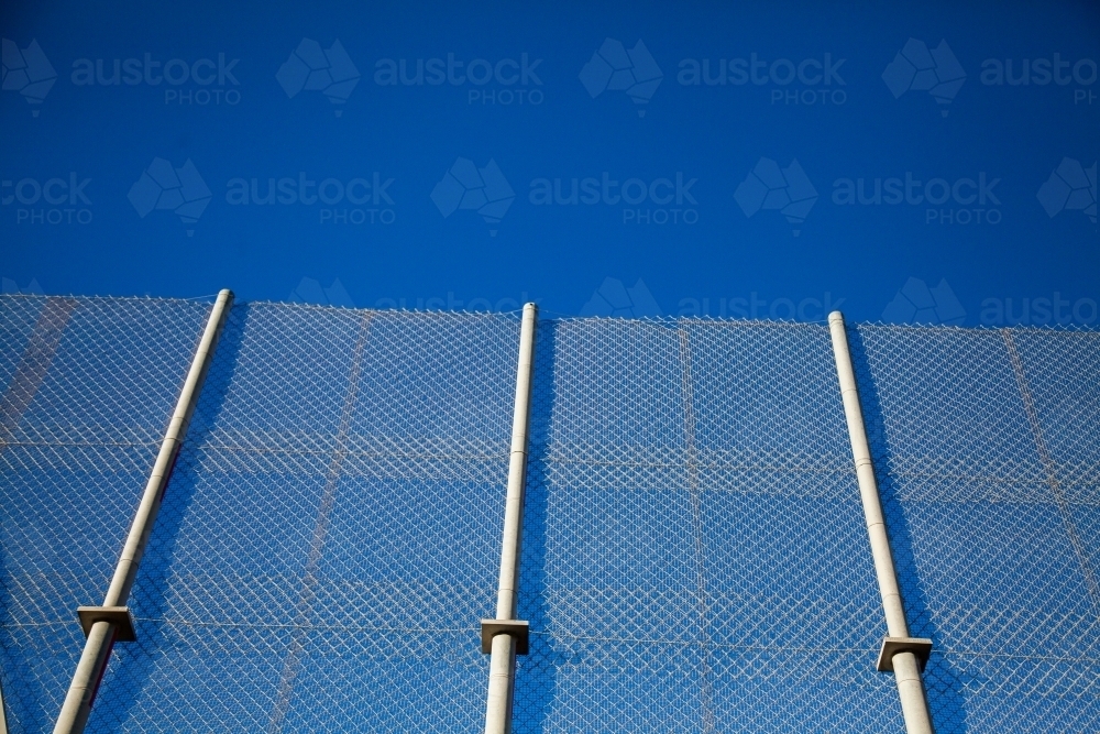 Three poles on a fence along a bridge for mine trucks - Australian Stock Image