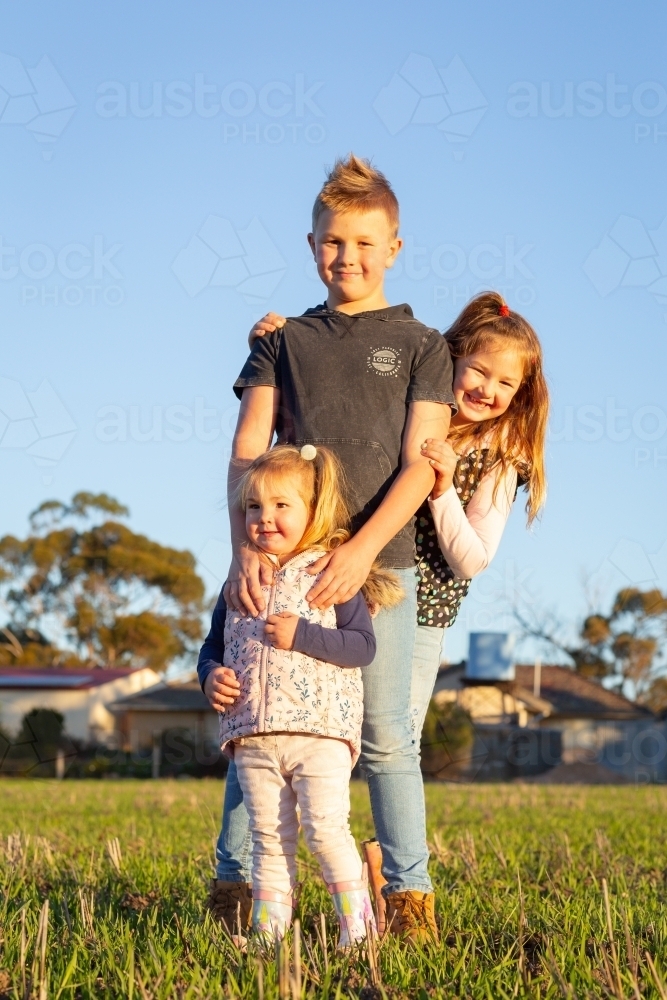 Three siblings aged under ten on a farm - Australian Stock Image