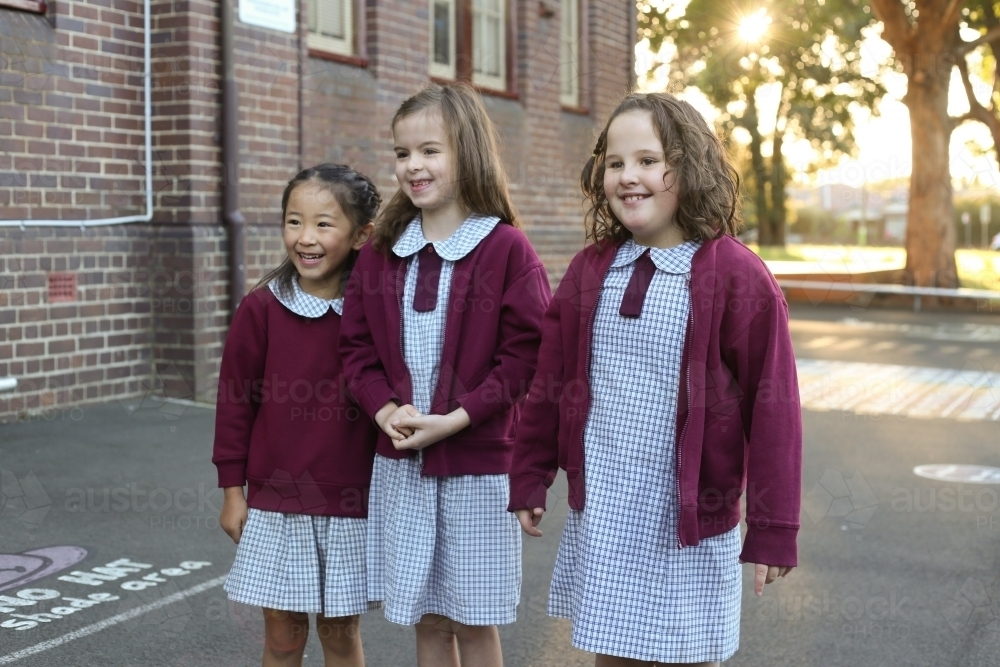 image-of-three-smiling-girls-outside-their-school-austockphoto