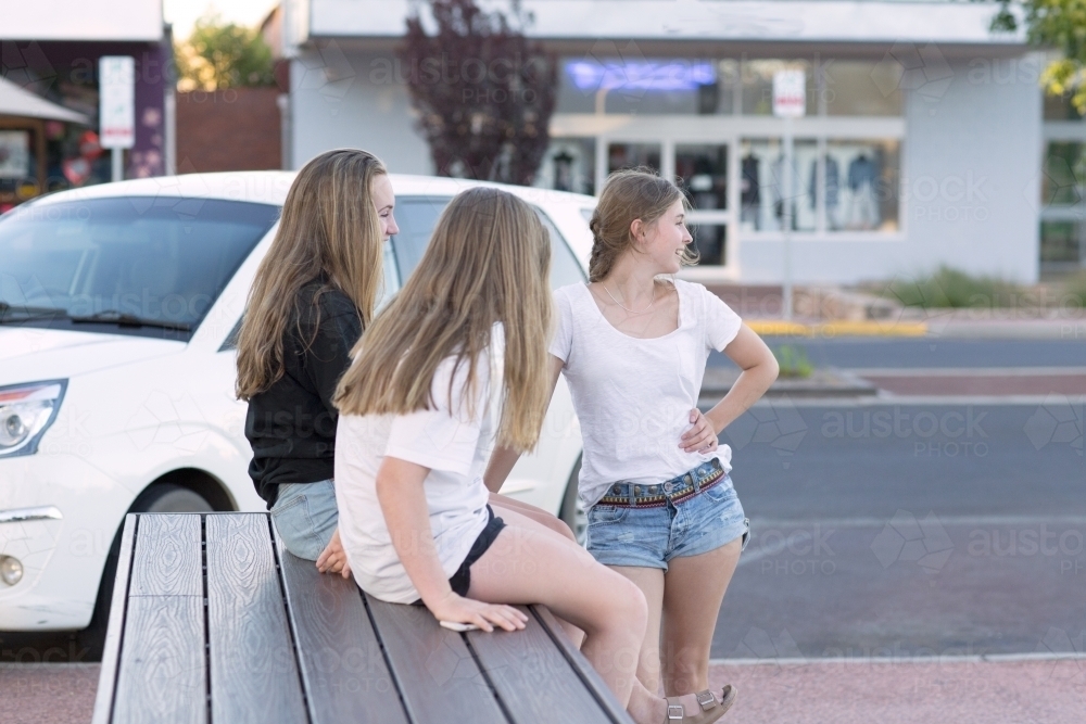 Three teenage girls hanging out in the street - Australian Stock Image