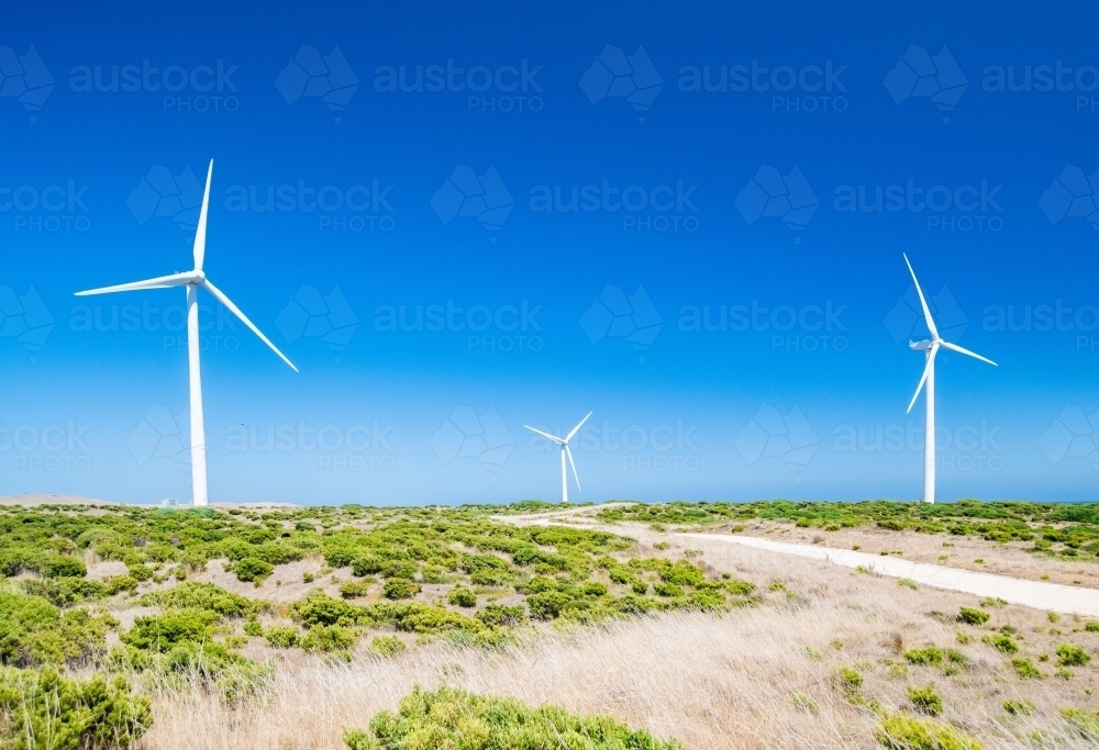 Three Wind turbines against the blue sky at a wind farm. - Australian Stock Image