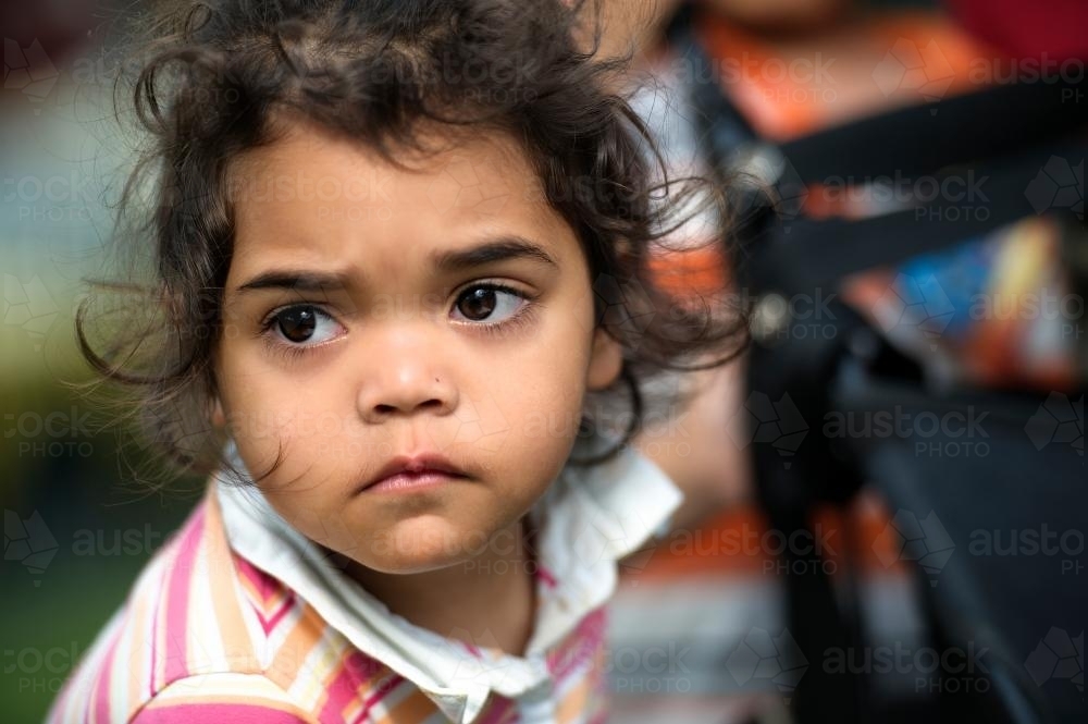 Three year old Aboriginal Girl Holding Pusher - Australian Stock Image