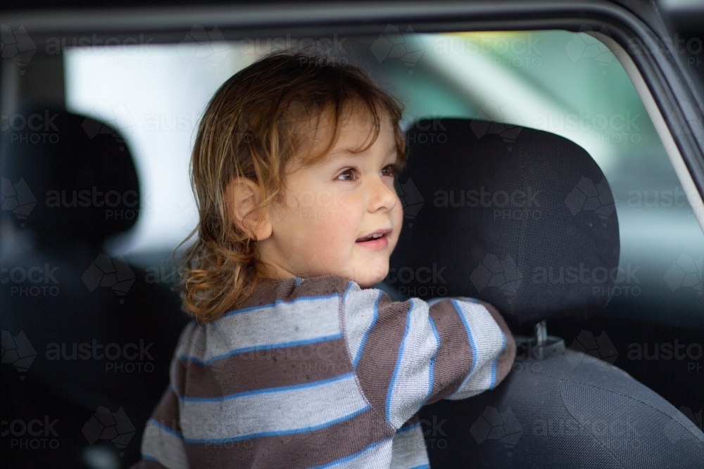 Three-year old in back of car - Australian Stock Image