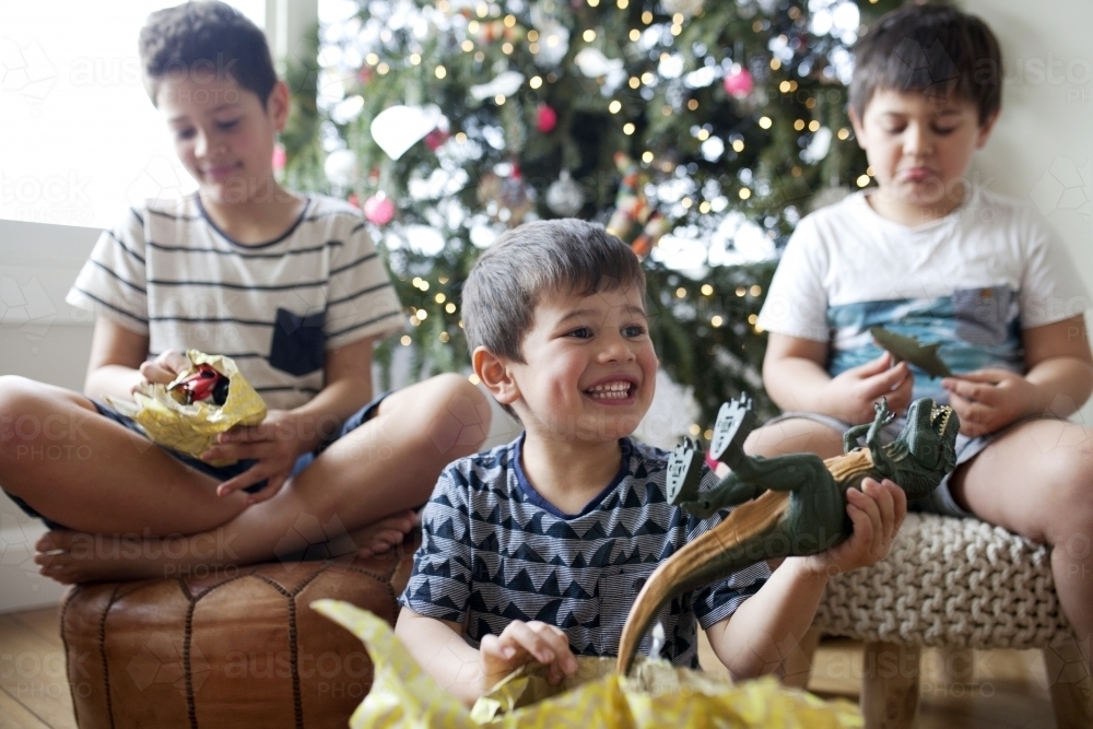 Three young boys opening Christmas presents - Australian Stock Image