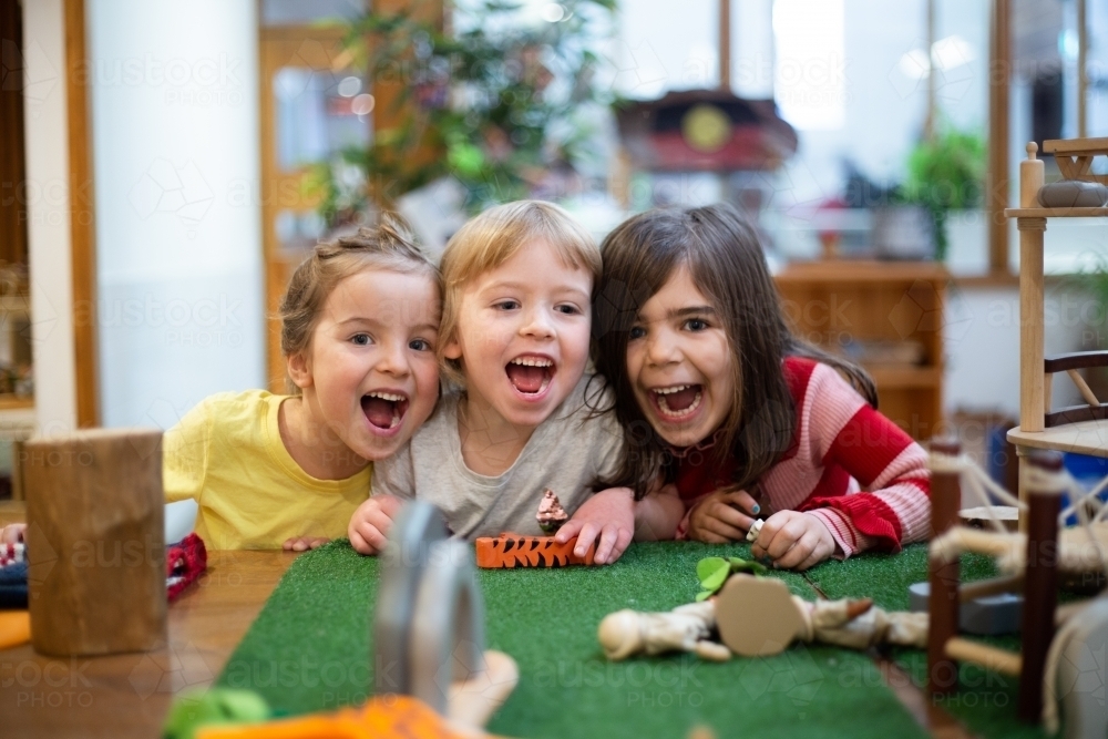 Three young girl friends smiling and laughing - Australian Stock Image