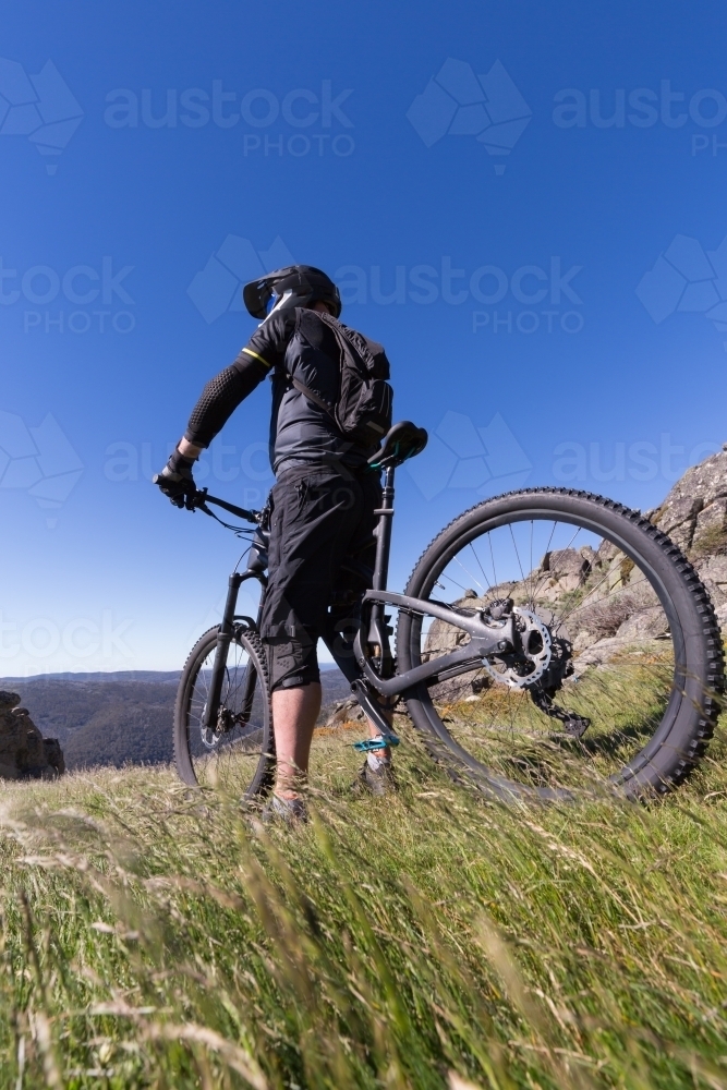 Thrill seeker about to ride his mountain bike down a Thredbo trail - Australian Stock Image