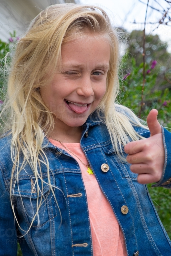 Thumbs up and poke your tongue out when your happy - Australian Stock Image