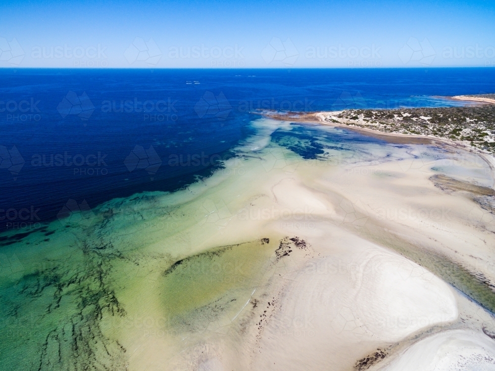 Tidal flats with creek running out to sea - Australian Stock Image