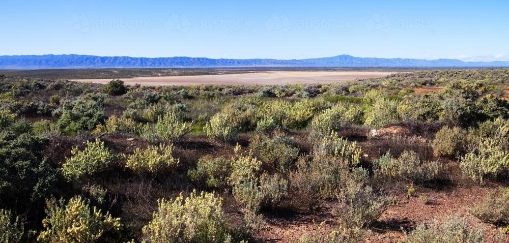 Tidal flats with mountain range in the distance - Australian Stock Image