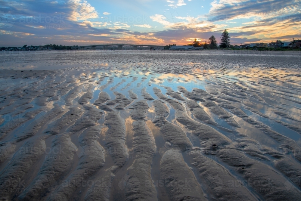 Image of Tidal sand flat at sunset with sand ripples - Austockphoto
