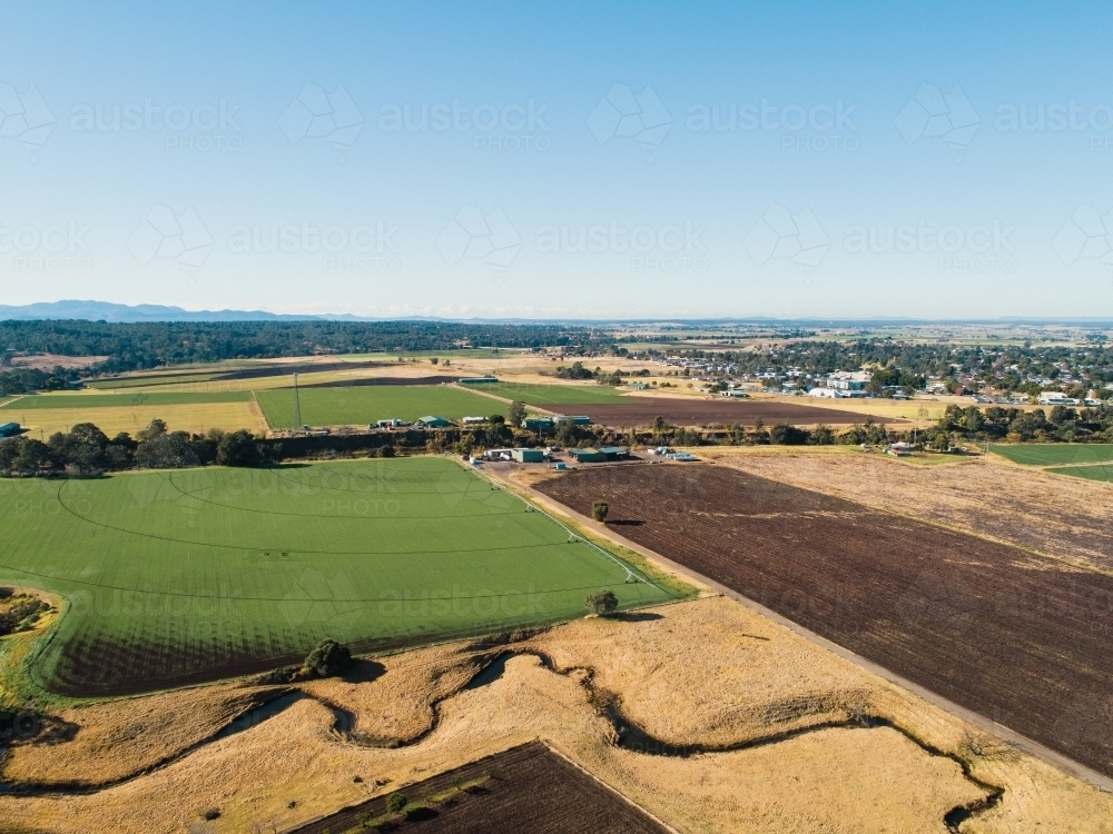 Tilled brown farm paddocks on floodplain flats in Singleton, NSW - Australian Stock Image